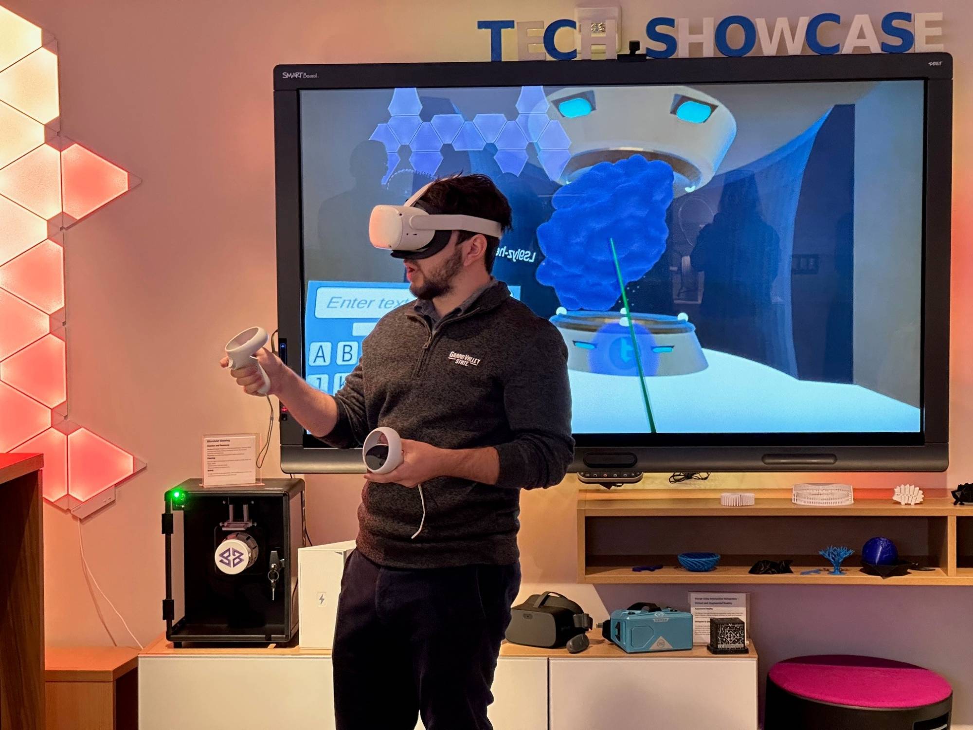 Man with VR headset in the Technology Showcase viewing protein molecules in 3D.